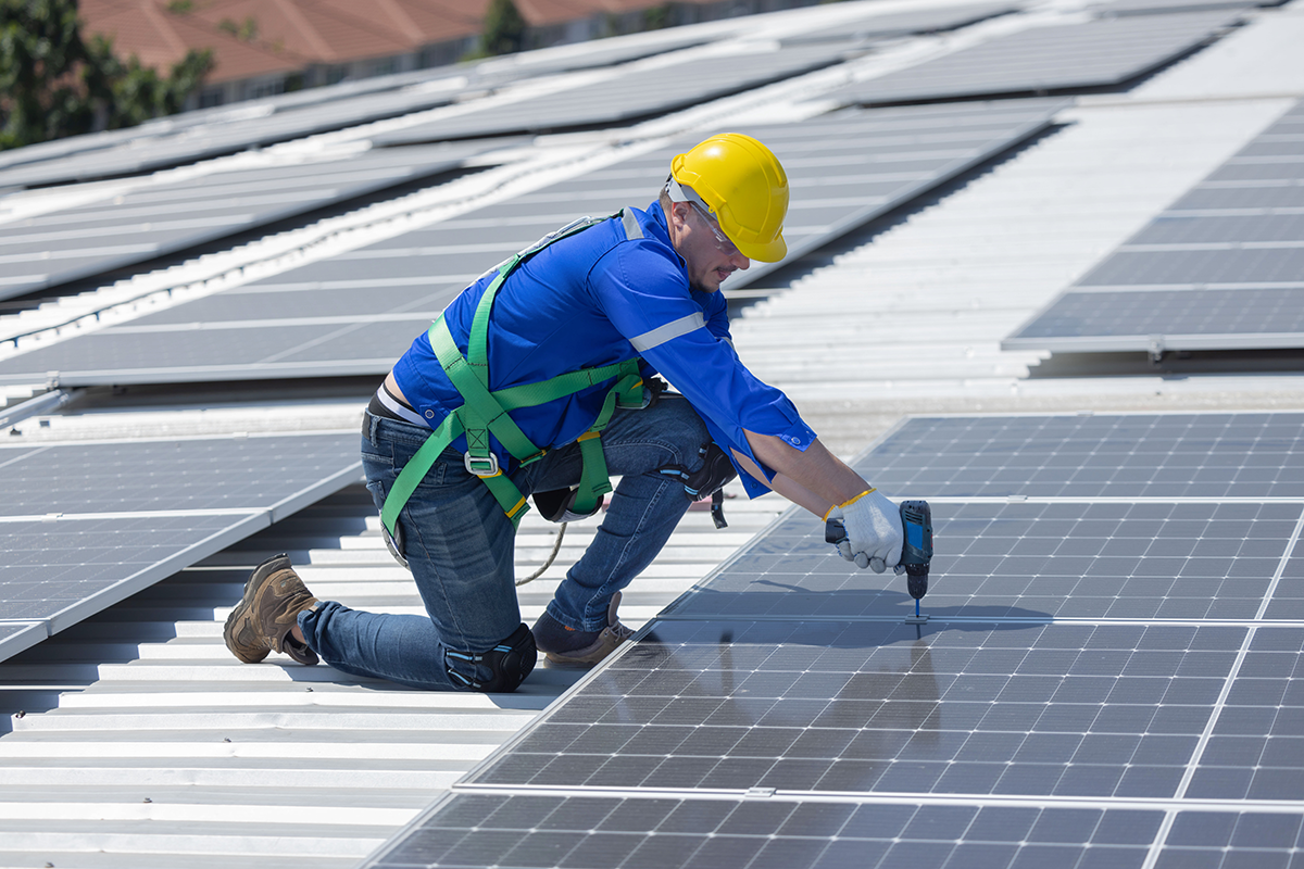 Technician inspecting solar array